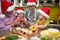 Grandpa, grandma and grandchildren at the kitchen together enjoying preparing vegetables for a Xmas meal. Christmas, family,