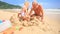 Grandpa Kids Build Sand Castle on Beach by Wave Surf