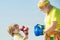 Grandpa and little child boy in boxing stance doing exercises with boxing gloves. Elderly man hitting punching bag