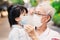 Grandpa spoke with her grandchild to understand how to wear a face mask to help prevent the spread of coronavirus and PM2.5.