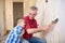 Grandpa takes off wallpaper and laughing with his grandson