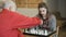 Grandpa teaches granddaughter to play chess