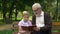 Grandpa teaches grandson to read book, encourages boy to knowledge, education