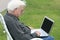 Grandpa using a laptop at golf