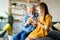 Grandparent enjoy spending time laughing with little girl grandchild at home