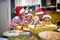 Grandparent and grandchildren having good time in the kitchen together at Xmas meal preparation. Christmas, family, together