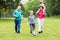 Grandparent And Grandchildren Playing Soccer Ball Together