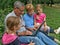 Grandparent, twins grandchild with laptop