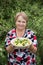 Grandparent woman with boiled potatoes in the plate