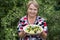 Grandparent woman with boiled potatoes in the plate