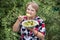 Grandparent woman with boiled potatoes in the plate