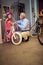 Grandparents buying new bicycle and helmets for little girl