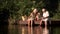 Grandparents and child near river.