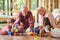 Grandparents and children play with building blocks