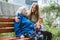 Grandparents Day, Reunited family, togetherness. Senior old grandma hugs granddaughter outdoors. Grandchild makes