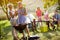 Grandparents drink wine and enjoying picnic