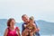 Grandparents enjoying day with granddaughter while blowing soap bubbles on the beach near the sea