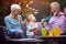 grandparents enjoying with  granddaughter and playing with paper boat