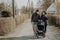 Grandparents in facial masks walking with baby in buggy during quarantine