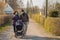 Grandparents in facial masks walking with baby in buggy during quarantine