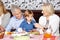 Grandparents feeding grandson at