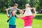 Grandparents Giving Grandchildren Piggyback Ride In Park