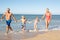 Grandparents With Grandchildren On Beach.