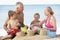 Grandparents And Grandchildren Enjoying Beach Holiday