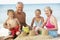 Grandparents And Grandchildren Enjoying Beach Holiday