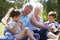 Grandparents And Grandchildren Playing Football In Garden