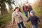 Grandparents With Grandchildren On Walk In Countryside