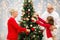 Grandparents and granddaughter at christmas tree