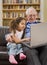Grandparents and granddaughter with computer