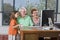 Grandparents and granddaughter with computer