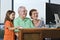 Grandparents and granddaughter with computer