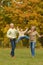 Grandparents with granddaughter having fun in park