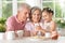 Grandparents with granddaughter using smartphone