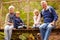 Grandparents with grandkids on bridge in a forest, portrait