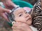 Grandparents hands washing cute child hair outdoor