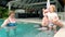 Grandparents having fun with child in swimming pool