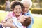 Grandparents Having Fun In Park With Grandson