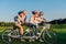 Grandparents helping children ride bicycle