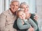 Grandparents, hug and portrait on sofa with child, care and bonding with love, retirement and home living room. Happy