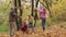 Grandparents and kids having fun in autumn park