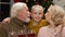 Grandparents kissing cute granddaughter, old couple happy to see child at Xmas