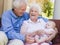 Grandparents outdoors on patio with baby