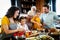 Grandparents, parents and children spending happy time in the kitchen