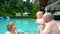 Grandparents playing with baby girl in swimming pool