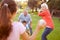 Grandparents Playing Baseball With Grandchildren In Park