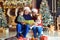 Grandparents read a book to children in Christmas